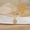 Detail of a rotating clover pendant in gold finish with sparkling pavé crystals - Four Leaf Clover Style (XL02153)
