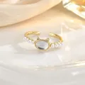 Detail of a cat-shaped ring with iridescent oval stone and white faux pearls on silk - Cat Head Cat's Eye Stone Artificial Pearl Style (JZ0436)