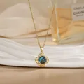 Macro detail of rotating flower pendant with blue celestial stone and zircon accents - Dark Blue Starry Gem Flower Style (XL02161)