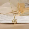 Detailed close-up of a rotating gold flower pendant necklace with sparkling crystal inlay - Round Hollow Flower Pave Style (XL02165)