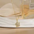 Close-up of rotatable flower necklace with gold plating and sparkling zircon stones - Pave Floral Star Style (XL02174)