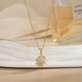 Detailed macro of a rotating gold sunflower pendant with sparkling white zircon stones - Pave Sunflower Style (XL02178)
