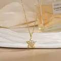 Detailed close-up of golden spinning flower pendant with zircons on white display - Star Floral Clear Gem Style (XL02180)