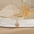 Close-up of golden necklace featuring a spinning flower pendant with pink zircons - Pink Zirconia Round Flower Cluster Style (XL02184)