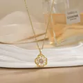 Close-up of rotatable golden flower pendant with clear zircons on a wavy white tray - Hollow Petal Pave Style (XL02186)
