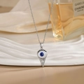 Collana Occhio di Allah in acciaio argento con ciondolo protettivo blu e cristalli bianchi - Stile Argento (XL02309G)