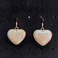 Macro detail of heart-shaped natural stone earrings with gold plated edges on velvet - Sky Blue Brown Texture (No. 10)