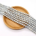 Faceted natural gray mother of pearl shell beads with iridescent luster on wooden tray - Faceted Round Bead Style (No. 3) / 8mm (50 Pieces/Strand) / Grey Silver (No. 3)