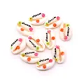 Macro shot of natural cowrie shells printed with dream text and colorful floral patterns - Dream Weaver Style