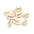 Detail of DIY natural shell beads with black friend text and colorful floral prints - Eternal Friend Style