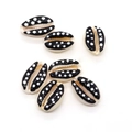 Macro detail of six hand-painted cowrie shells with black base and white polka dots for DIY - 9x19mm 1.5g / 20 Pieces Set / Black with White Polka Dots