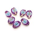 Macro detail of seven purple shell beads with blue eye patterns for DIY jewelry making - Purple Blue Eye (Style 1)