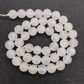 Macro shot of polished moonstone beads with blue flashes on a dark textured background - 6mm / Moonstone (No. 2)