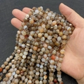 Brown and grey hexagonal faceted agate beads strands held in hand for DIY jewelry - 6mm / Banded Agate