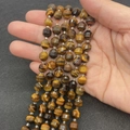 Faceted tiger eye stone barrel beads for DIY bracelets held in hand to show size - Tiger's Eye