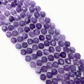 Macro view of faceted purple gemstone beads for DIY jewelry with natural mineral texture - Amethyst