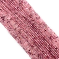 Macro shot of faceted pink natural stone beads with fine textures for DIY jewelry making - Strawberry Quartz