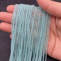 Faceted light blue cat eye stone beads 2-3mm strand held for size reference - Sky Blue (No.13)