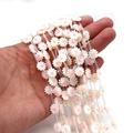 Pink and white shell daisy beads for DIY jewelry making shown in hand view - 10mm (20 Pcs/Strip) / Pink Heart (No. 3)