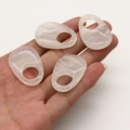 Set of four translucent rose quartz oval gemstone rings with natural pink stone finish - White Crystal