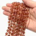 Faceted translucent orange natural stone beads strands with small clear spacer beads - Sunstone