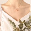 Rose gold pig pendant necklace with red heart detail worn by model on cable chain - 40+5cm