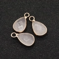 Three teardrop pink quartz pendants with gold plated edges on a black background - White Crystal / 10x18mm (3 Pieces/Pack)