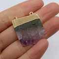 Handheld view of a natural purple amethyst pendant with gold plated double loop edges - Purple Gold (No.1)