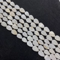 Macro view of hand-carved white mother of pearl shell leaf-shaped beads for DIY jewelry - Leaf Shape