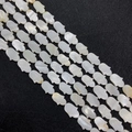 Macro view of iridescent Hamsa hand shaped natural mother of pearl shell beads for DIY jewelry - Hand Shape