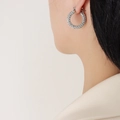 Elegant silver U-shaped hoop earrings with micro-paved diamonds on a model - Steel