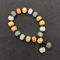 Macro detail of pumpkin shaped natural stone beads in green and yellow for DIY jewelry - No. 2 - Green Orange Yellow White Purple Multi-Color
