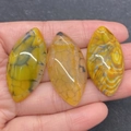 Handheld view of marquise-shaped yellow dragon vein agate beads for DIY jewelry making - No.11 (Yellow Banded Agate)