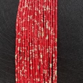 Macro detail of red imperial jasper tube beads with natural marbling for DIY jewelry - 2x4mm / Red Emperor Stone