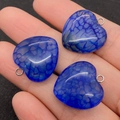 Macro shot of three blue cracked agate heart pendants with silver metal bails held in hand - Blue Style (2)
