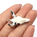 Resin steer skull pendant with silver plated horns held in hand for scale - 27x31mm / US 6