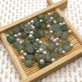 Golden stainless steel chain with pale green stones and white pearls on wooden tray - Irregular Size Roll / Green Aventurine