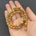 Handheld view of irregular 5x7mm orange and green imperial jasper beads for DIY jewelry - 5X7mm / Orange Green Mixed Style (No. 2)