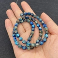 Deep blue irregular 5x7mm turquoise emperor stone beads held in palm for size scale - 5X7mm / Blue Brown Mixed Style (No. 6)