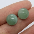 Green aventurine stone 12mm round cabochon earrings held between fingers showing size - Green Aventurine