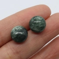 Natural 12mm Green Aventurine round stone studs displayed on a finger for scale - Aventurine Texture (6)