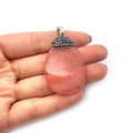 Handheld view of a teardrop-shaped pink strawberry quartz pendant with pavé diamond bail - No.3 (Strawberry Quartz Color)