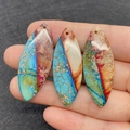 Three oval-shaped imperial jasper stones with unique blue and earthy marble textures - Style 3 (Sky Blue and Purple Multicolor)