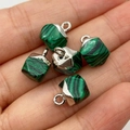 Malachite pattern cubic charms with silver metal caps held in hand for size visualization - Malachite