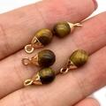 Tiger eye teardrop stone charms with gold metal caps held in hand for jewelry making - Tiger's Eye Style (5037910906840)