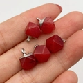Deep red geometric faceted natural stone pendants with silver metal caps in hand - Deep Red Stone