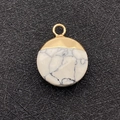 Macro detail of natural white stone pendant with golden metal top and mounting loop - Howlite
