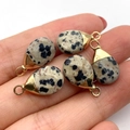 Handheld view of five teardrop Dalmation Jasper pendants with gold plated caps for DIY jewelry - 10x19mm 1g/pc / Dalmatian Jasper