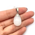 White agate teardrop pendant with silver bail held by hand against a white background - White Jade / 16x29mm