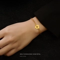 Golden daisy flower pendant bracelet with rectangular link chain on a model's wrist - Gold / 16cm